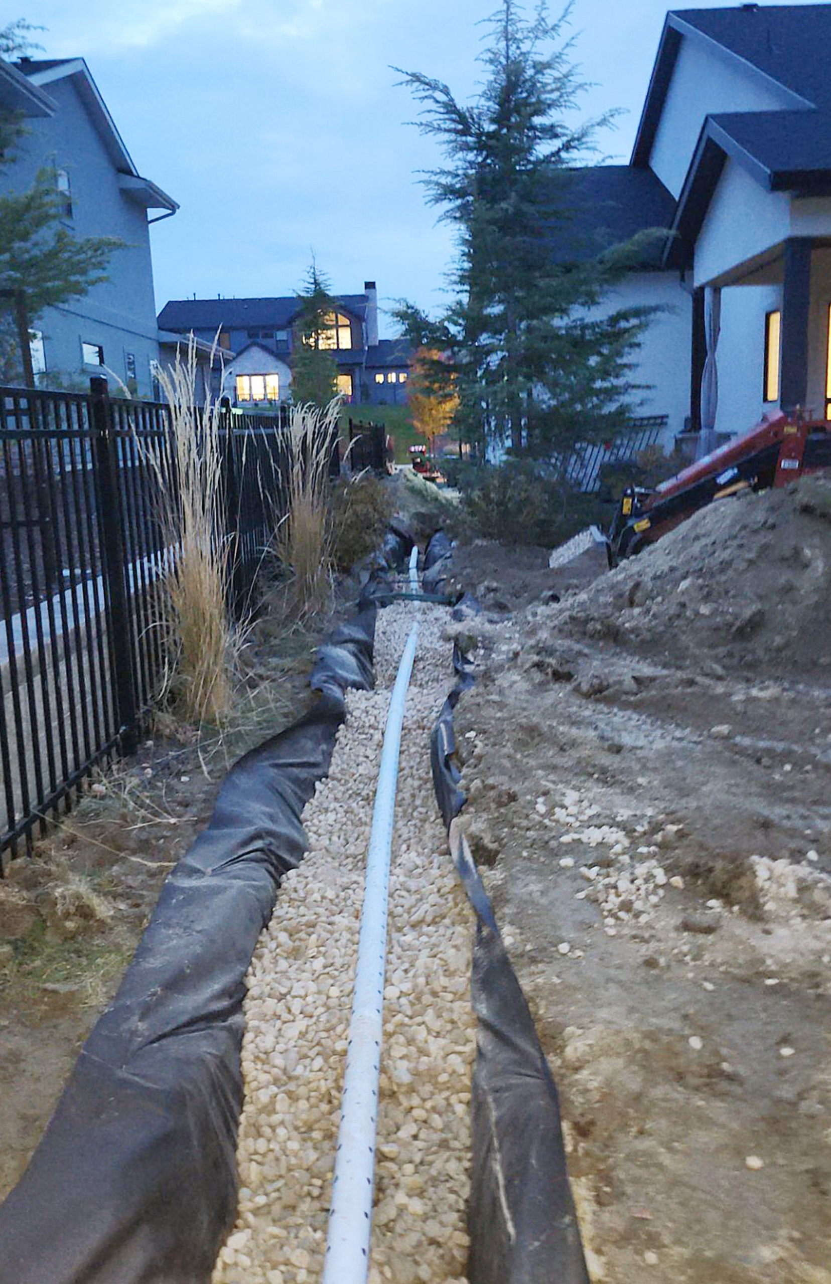 French drain with water Stones near House Wall